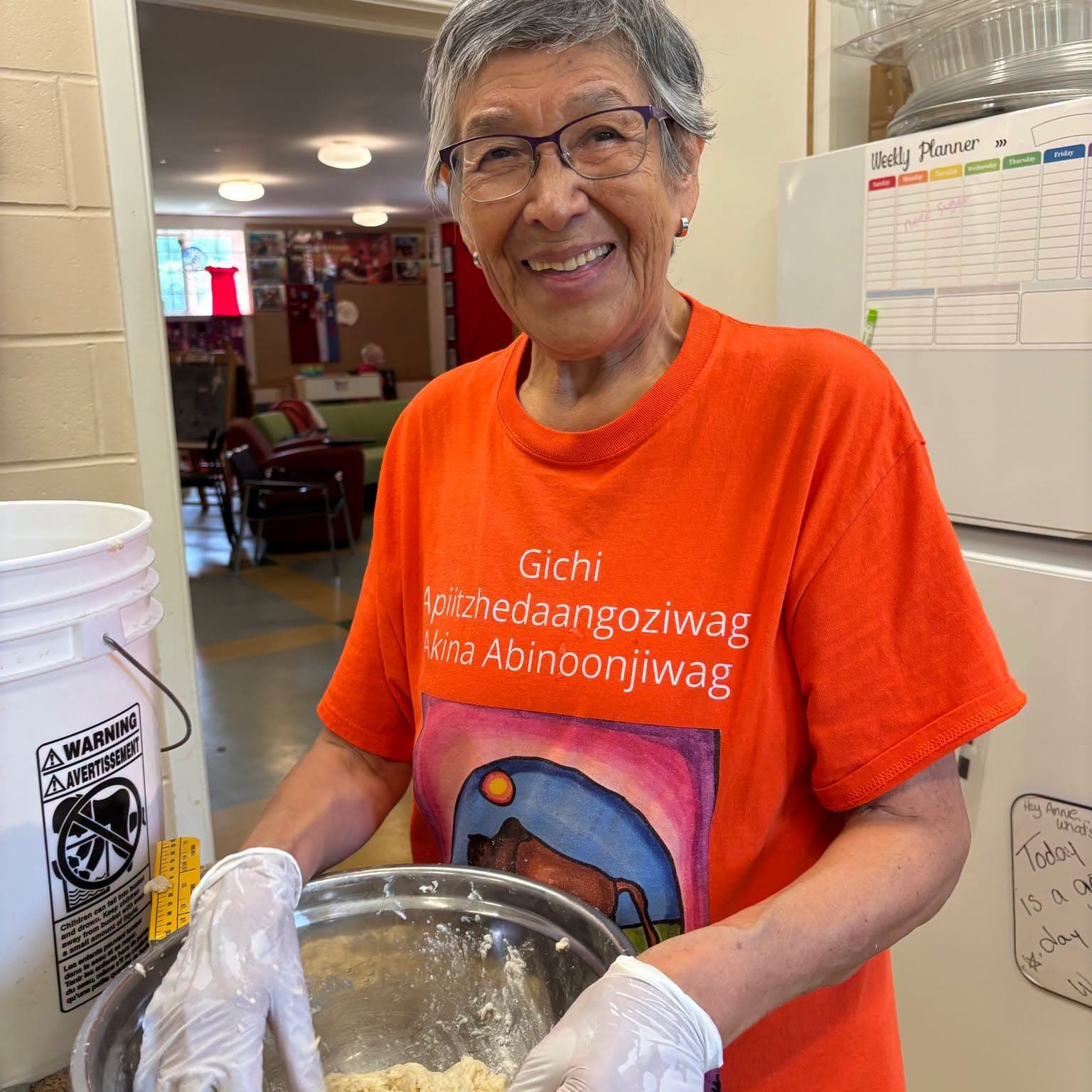 Community member serving food at the Centre